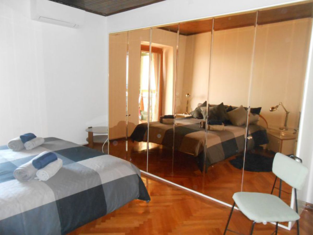double bed, mirrors and chair